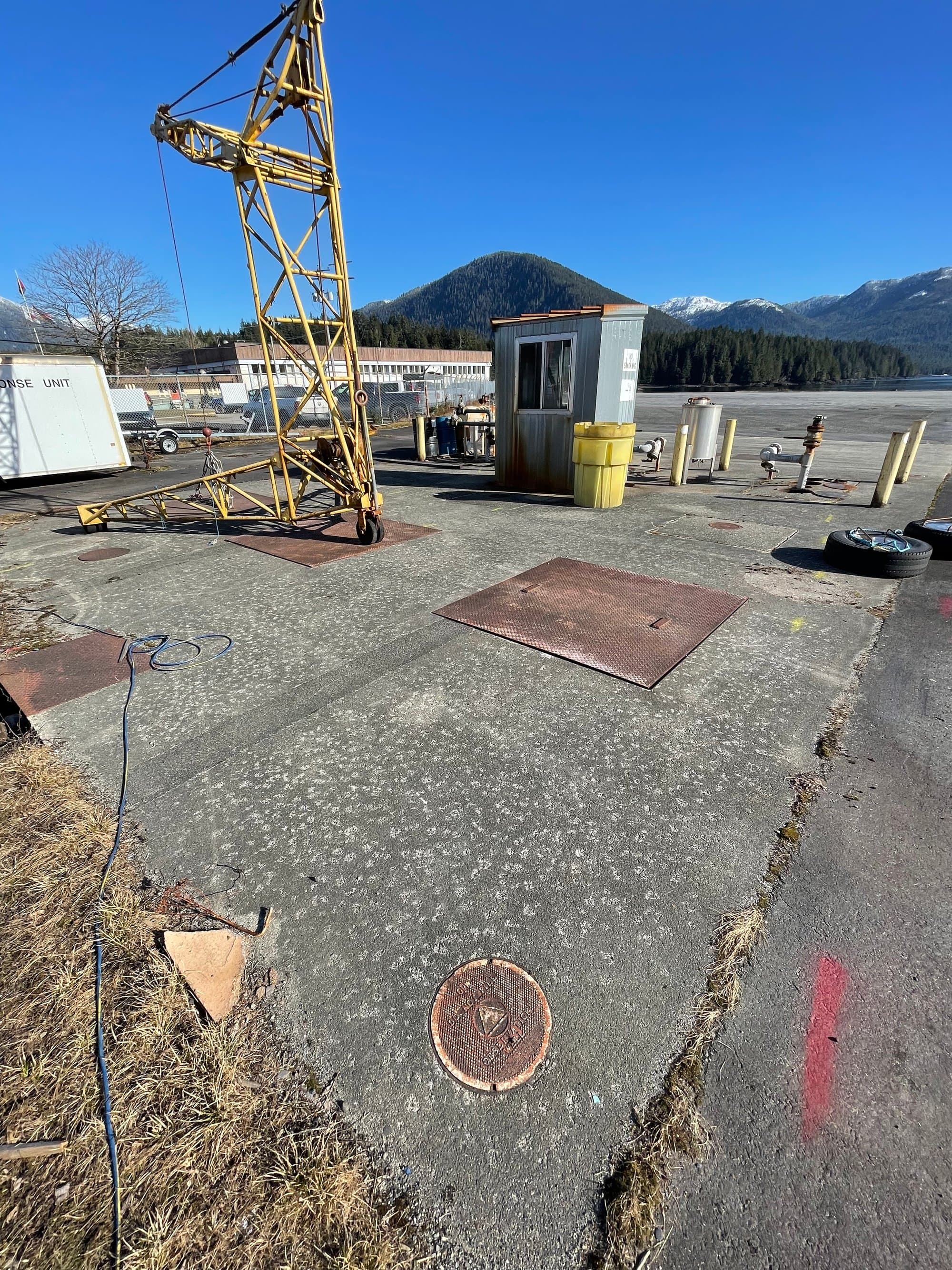 Industrial site survey with coastal mountains behind