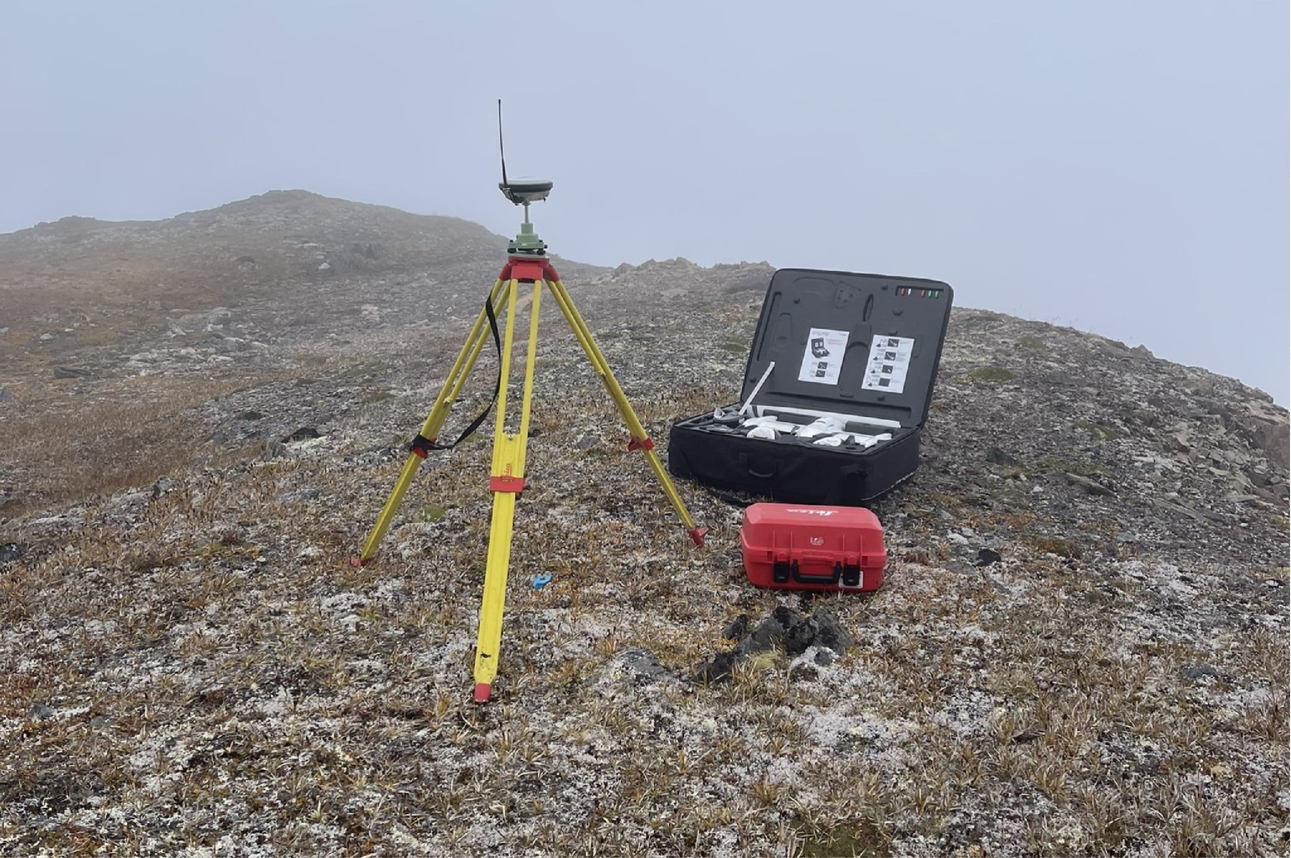 GNSS base station in fog on a rocky mountain summit