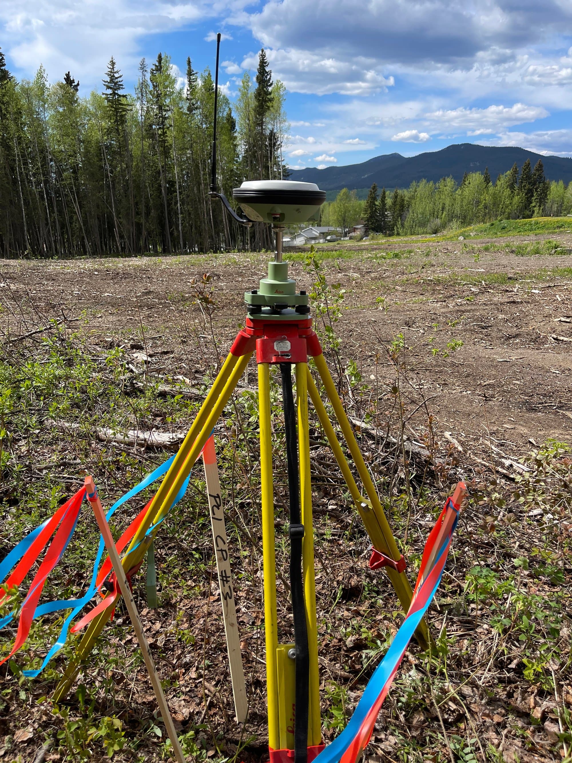 Control station and layout stakes on a cleared site