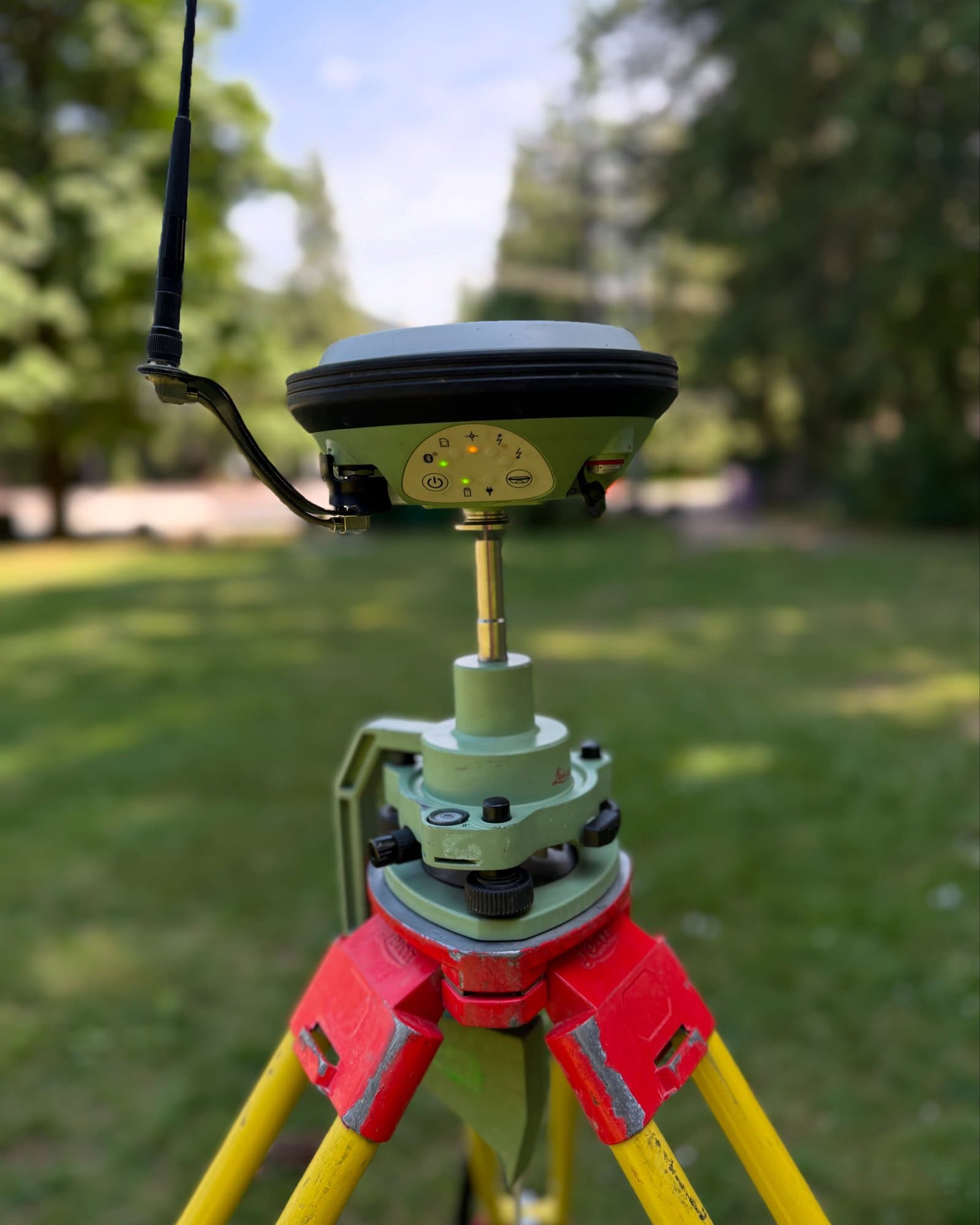 Survey-grade GNSS receiver set up over a control point