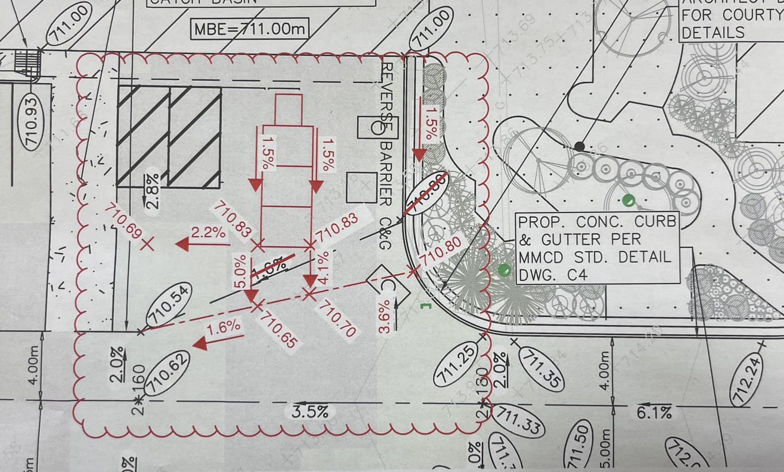 Civil grading plan with as-built elevations and slopes marked in red pen