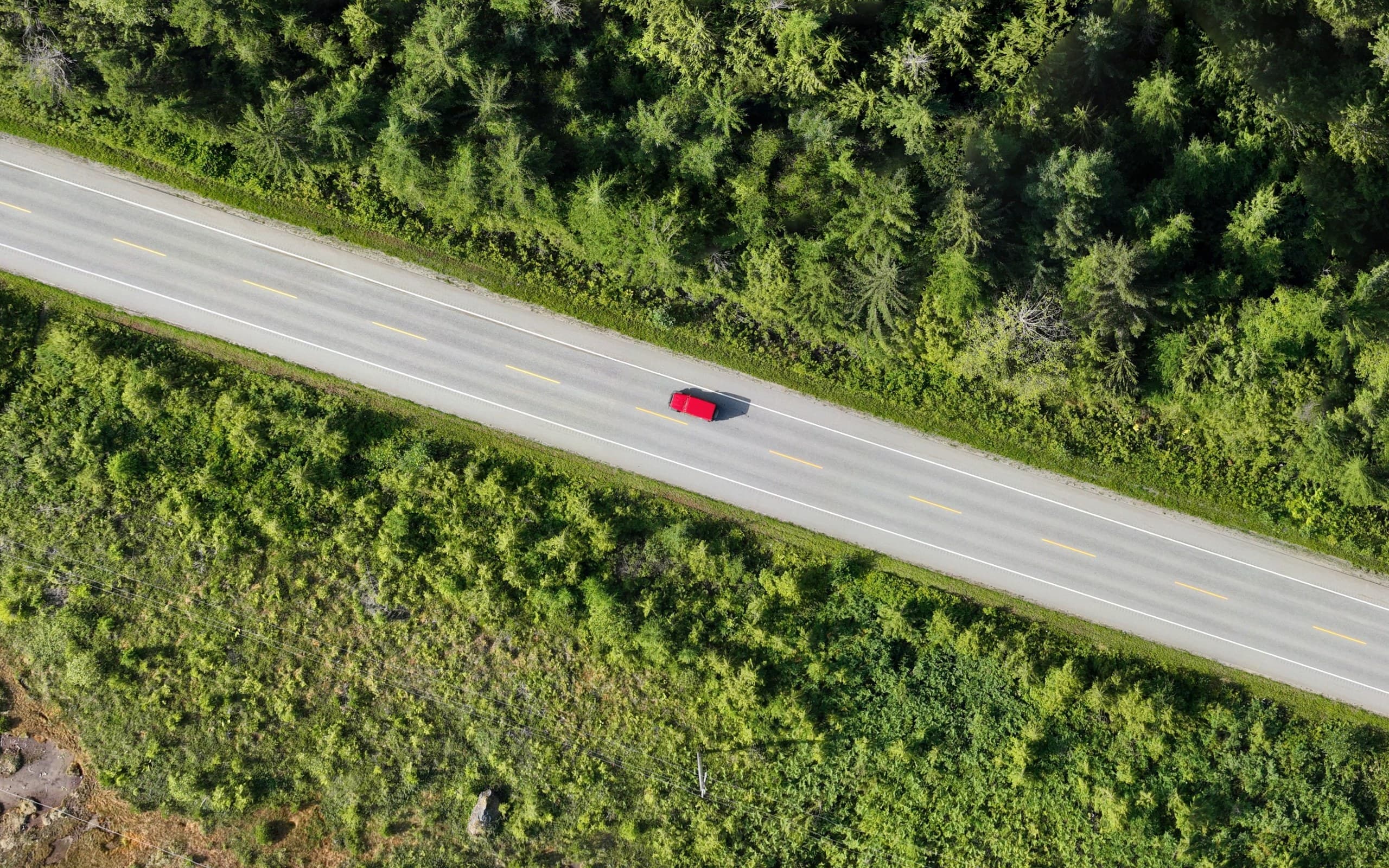 Orthophoto at full resolution showing lane markings and a vehicle on a highway