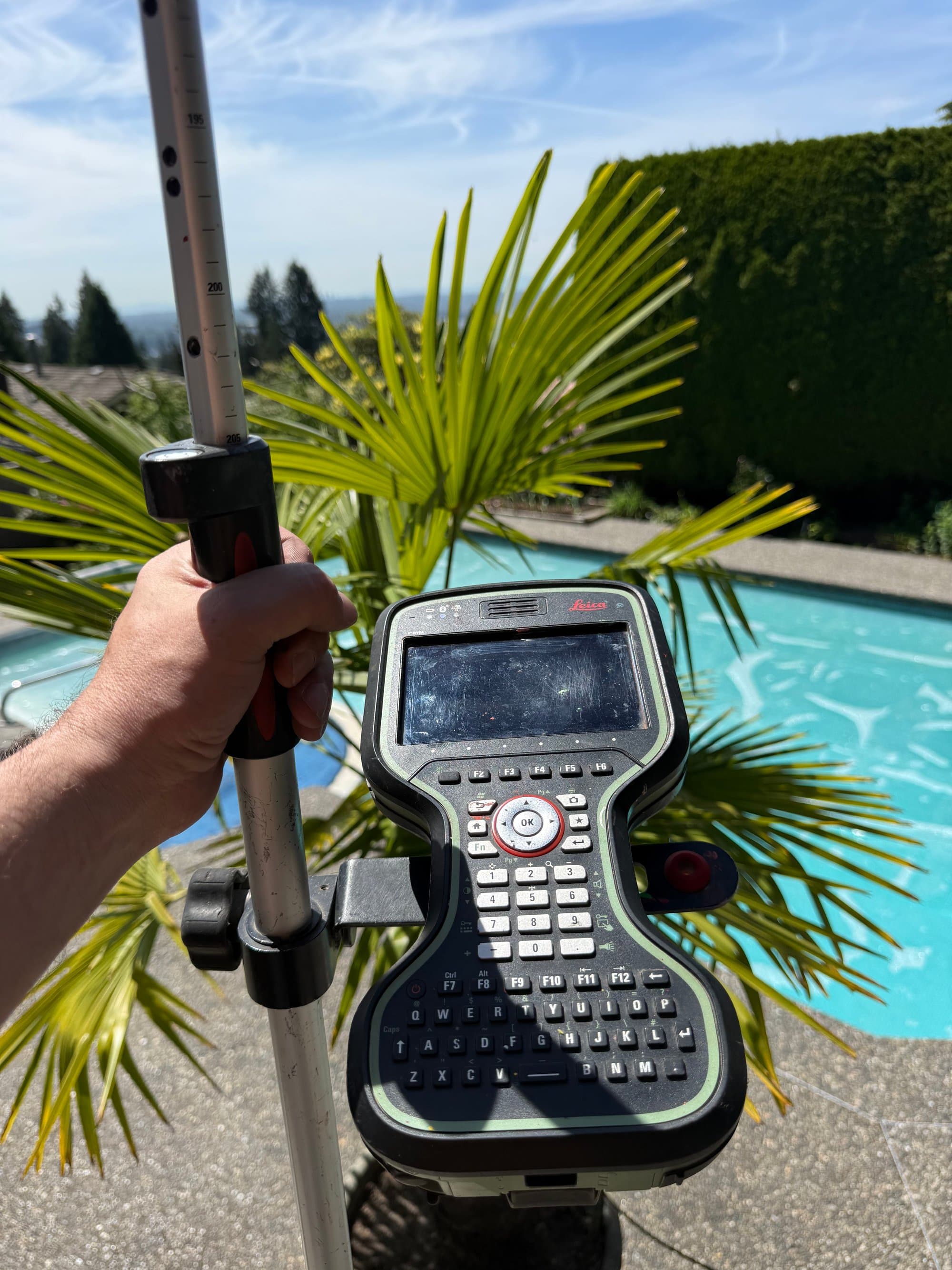 Survey rod and field controller during a residential pool survey
