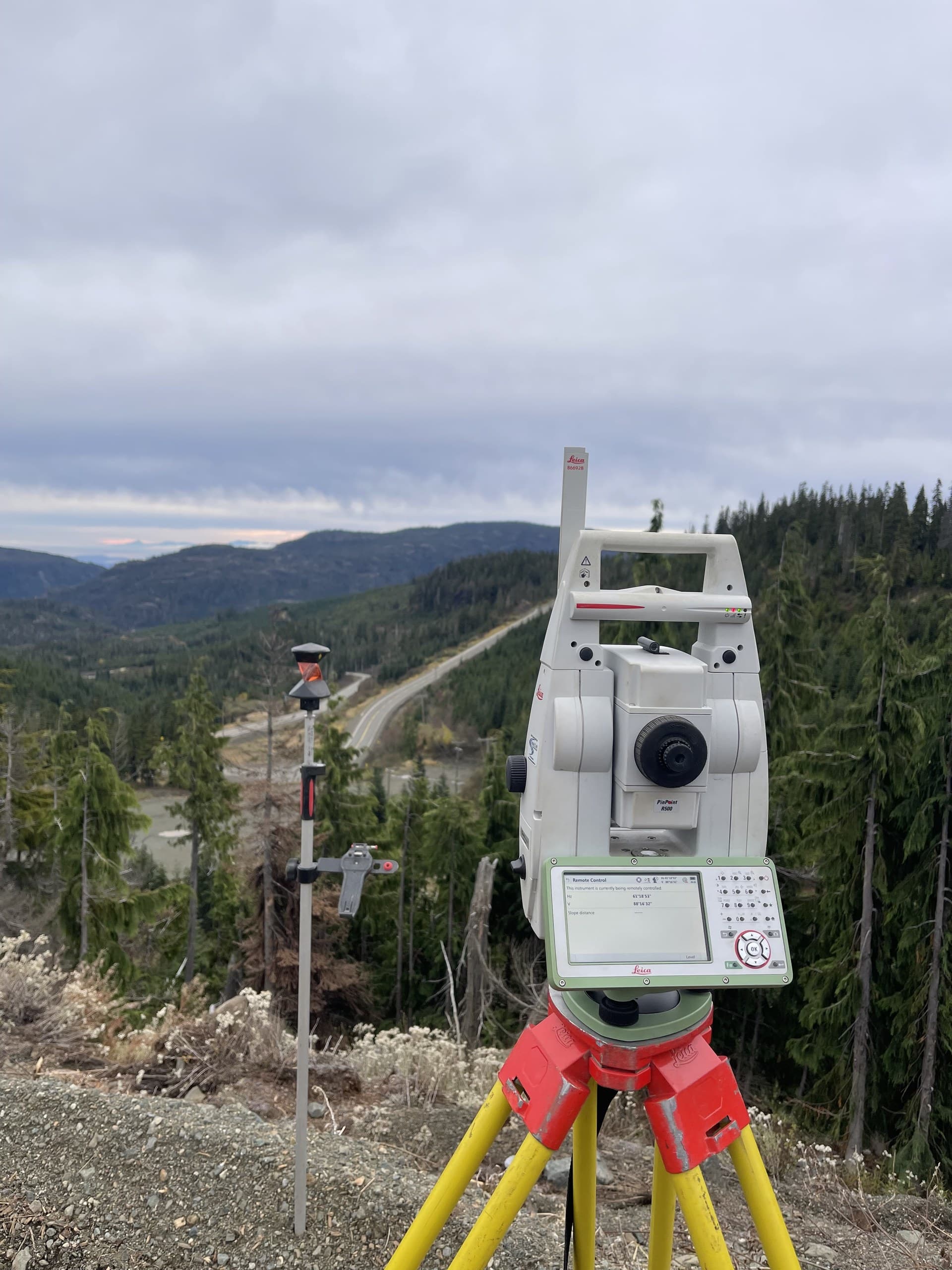 Robotic total station tracking a prism pole along a highway corridor