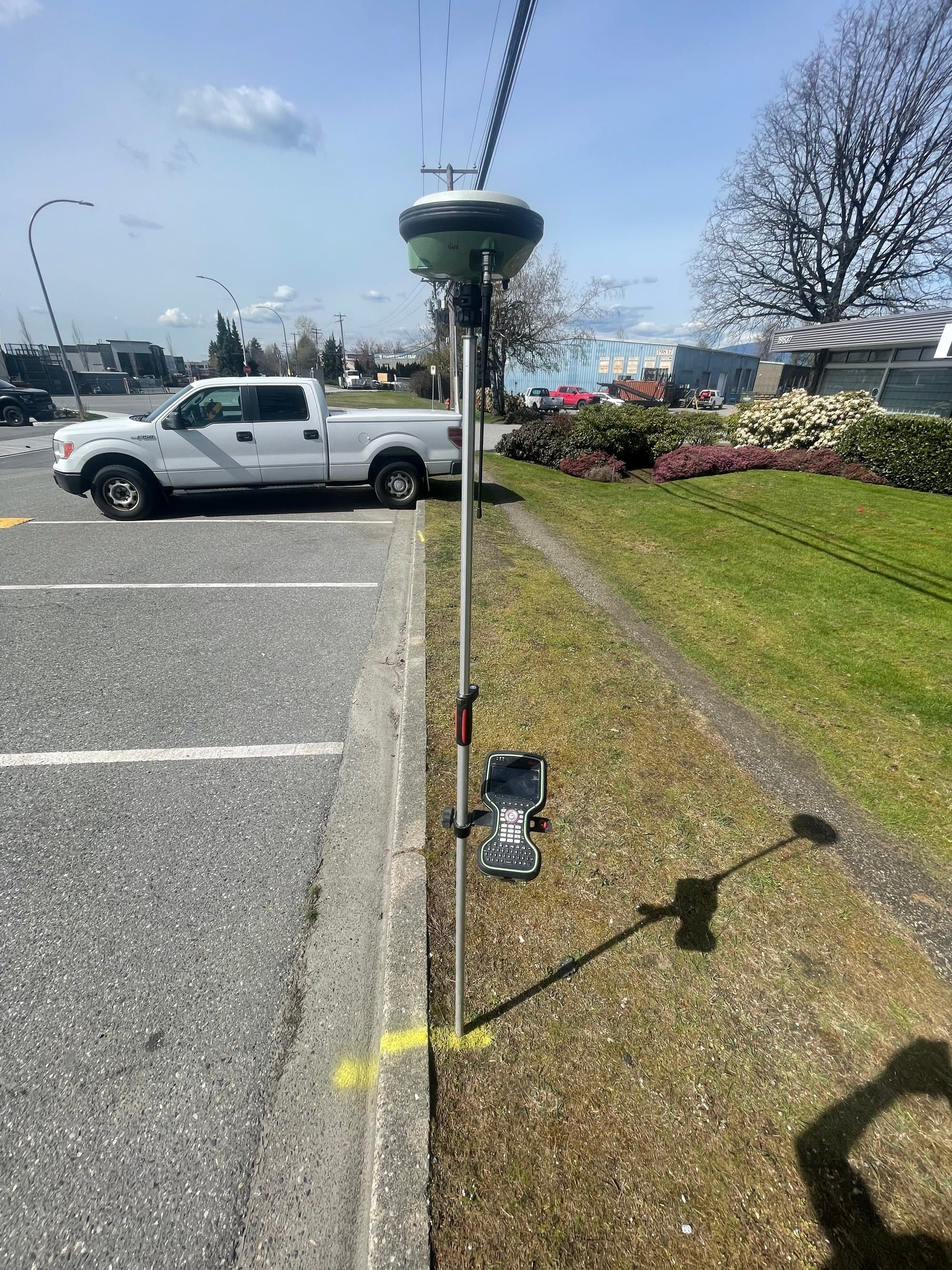 RTK rover recording an as-built measurement at a curb