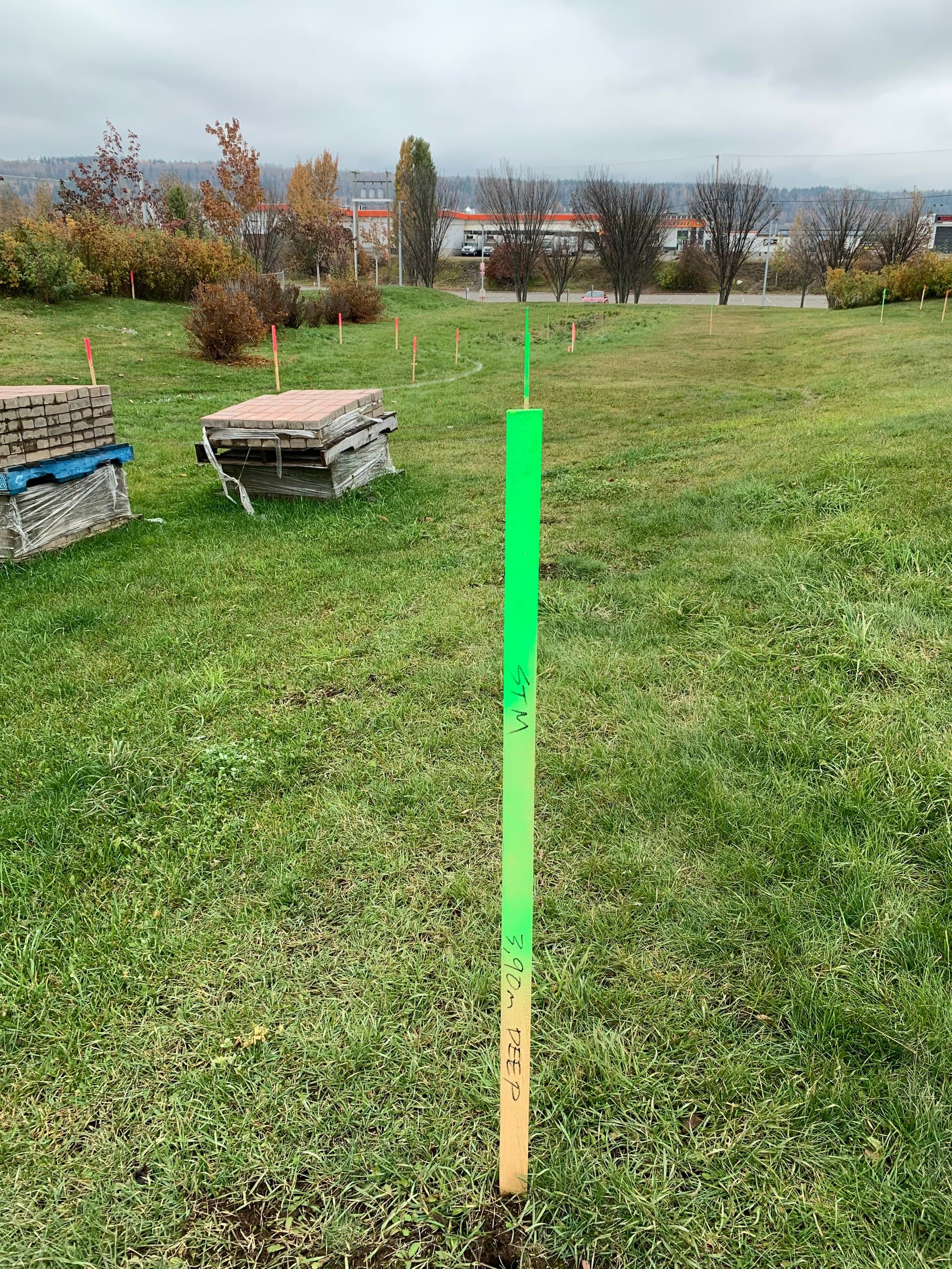 Site-servicing layout stakes across a development site