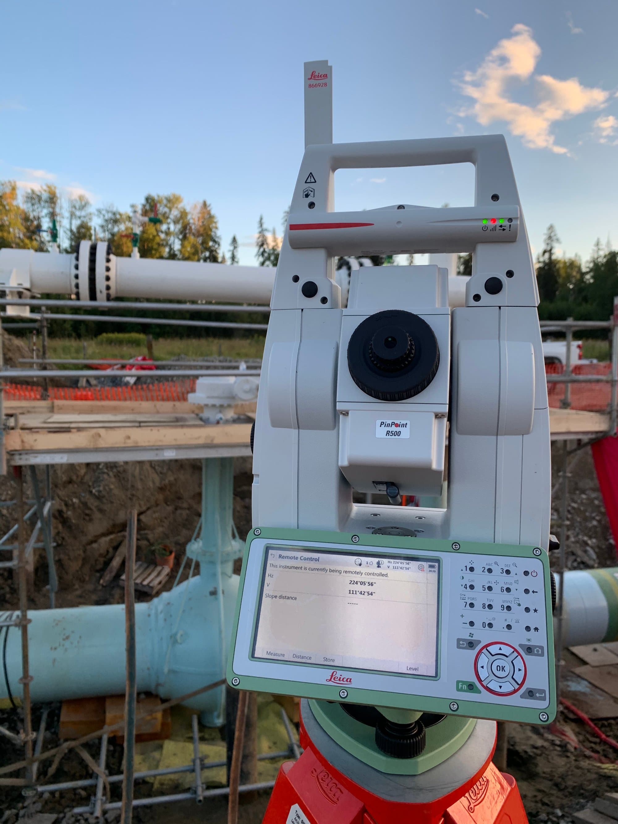 Robotic total station set up on an active industrial site